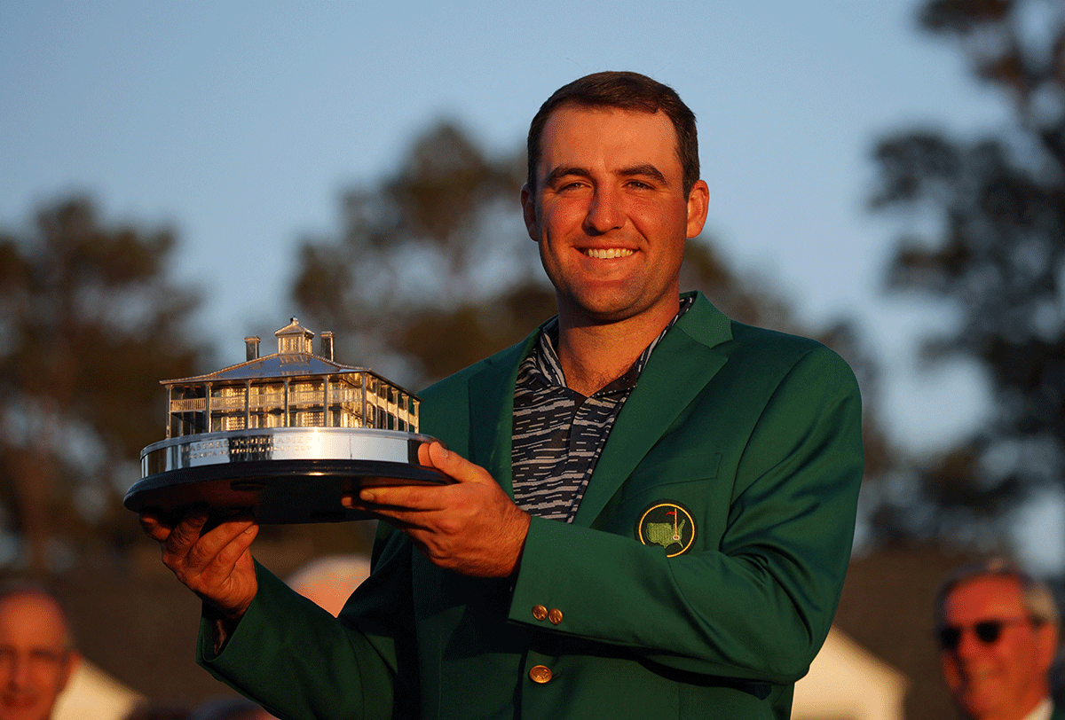 Scottie Scheffler of the U.S. poses in his green jacket with the trophy after winning The Masters at Augusta National Golf Club - Augusta, Georgia, on Sunday