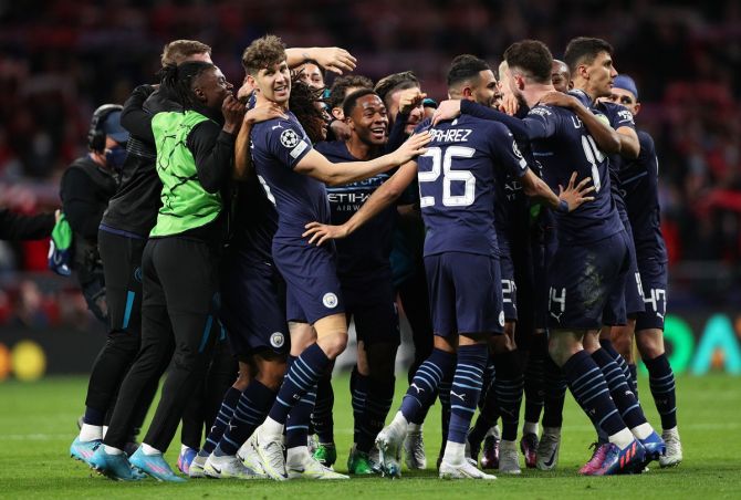 John Stones, Raheem Sterling and Riyad Mahrez rejoice with teammates after Manchester City finish with a goalless draw against Atletico Madrid and seal a place in the semi-finals, at Wanda Metropolitano in Madrid, Spain. 