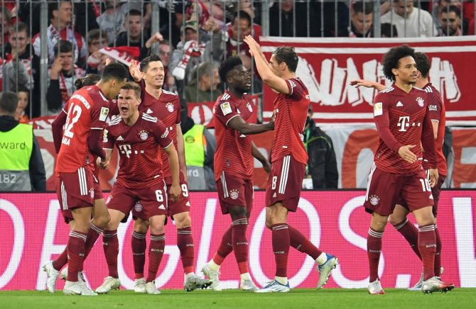 Jamal Musiala celebrates scoring Bayern Munich's third goal with teammates.