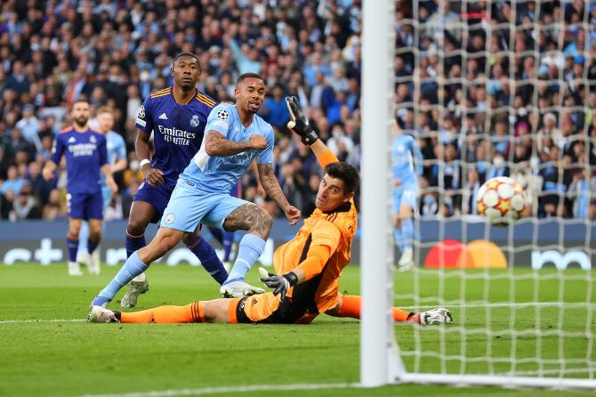 Gabriel Jesus beats goalkeeper Thibaut Courtois to score Manchester City's second goal.