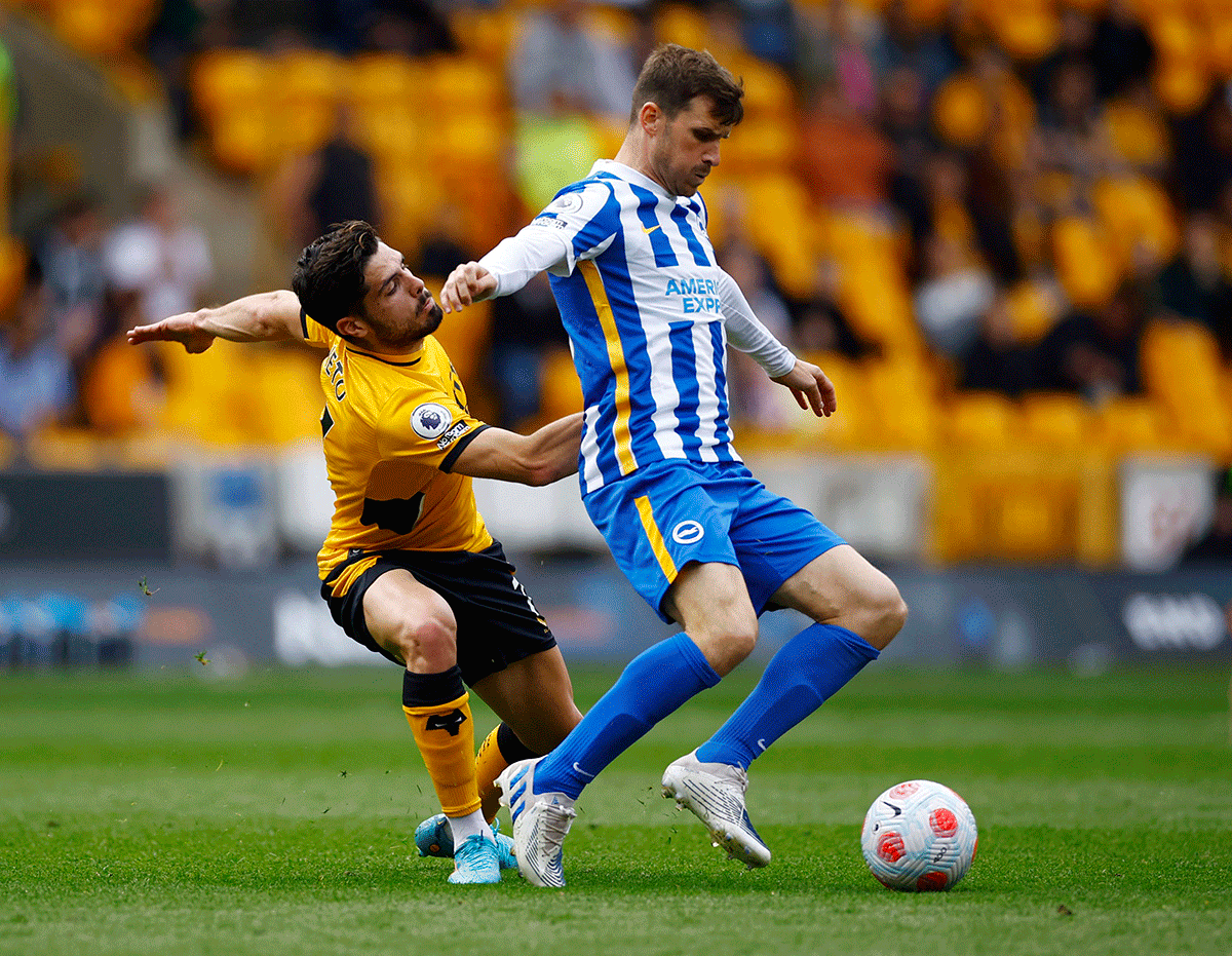 Wolverhampton Wanderers' Pedro Neto and Brighton & Hove Albion's Pascal Gross vie for possession during their match at Molineux Stadium, Wolverhampton, Britain 