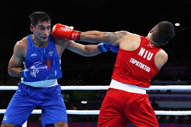 India's Ashish Kumar Kumar (Blue) directs a left hook on Niue's Travis Tapatuetoa during the Commonwealth Games men’s over 75kg-80kg light-heavyweight Round of 16 bout at NEC Arena in Birmingham on Monday.