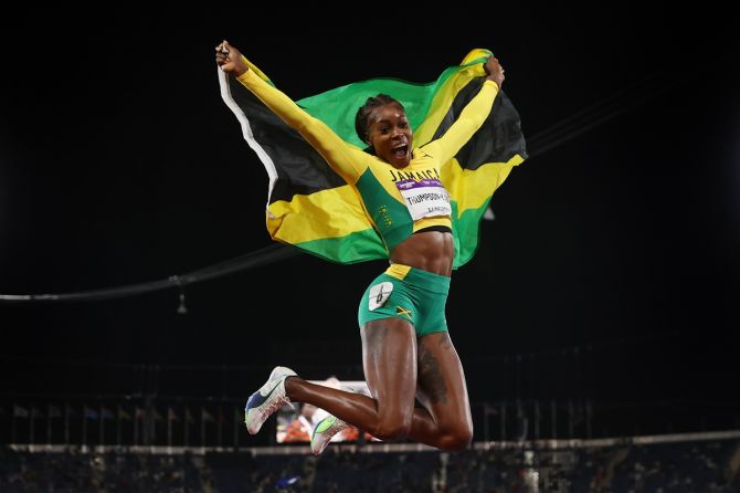 Jamaica's Elaine Thompson-Herah celebrates with her  country's flag after winning the women's 100m final on Wednesday, Day 6 of the Birmingham 2022 Commonwealth Games.