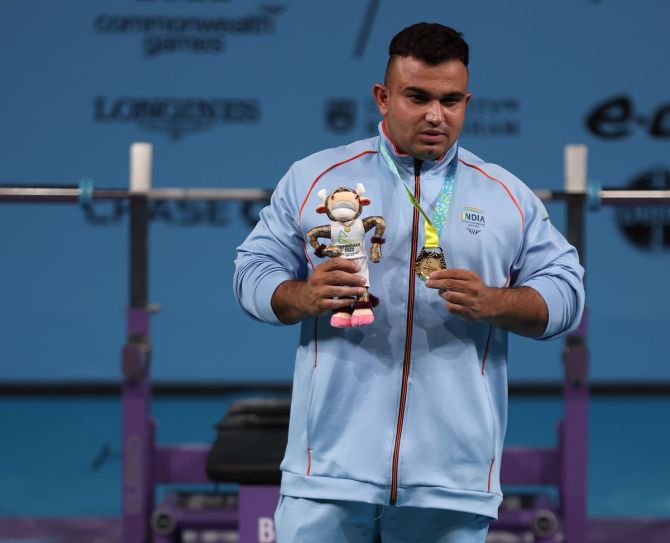 Sudhir celebrates on the podium with his gold medal from the men's heavyweight Para Powerlifting at the Commonwealth Games, at NEC Arena in Birmingham, on Thursday.