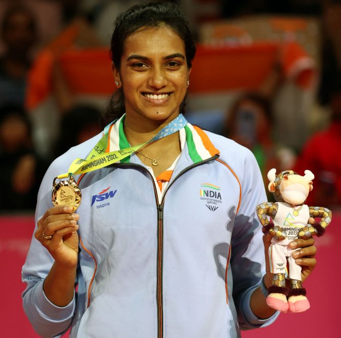 P V Sindhu celebrates on the podium after beating Canada's Michelle Li in the Commonwealth Games women's singles badminton final on Monday. 