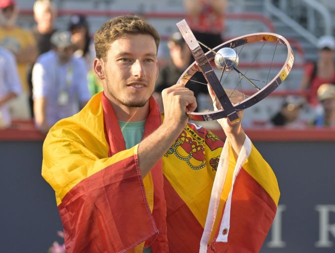 Spain's Pablo Carreno Busta poses with the championship trophy after beating Hubert Hurkacz in the singles final of the National Bank Open at IGA Stadium in Montreal, Canada, on Sunday.