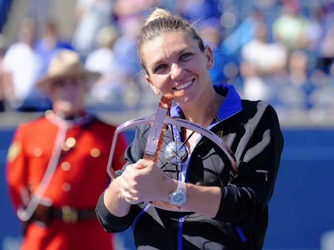 Romania's Simona Halep poses with the National Bank Open trophy after defeating Beatriz Haddad Maia in the women's final of the National Bank Open at Sobeys Stadium, in Toronto, Canada, on Sunday.