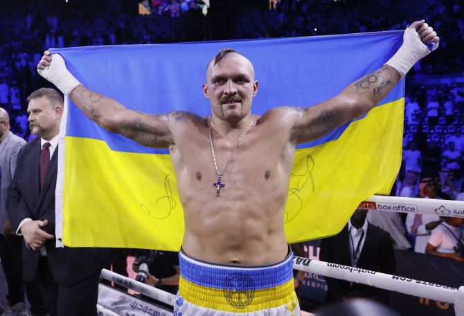Oleksandr Usyk celebrates with the Ukrainian flag after defeating Anthony Joshua for the WBA, WBO and IBF heavyweight World titles, at King Abdullah Sports City Arena, in Jeddah, Saudi Arabia, on Saturday.