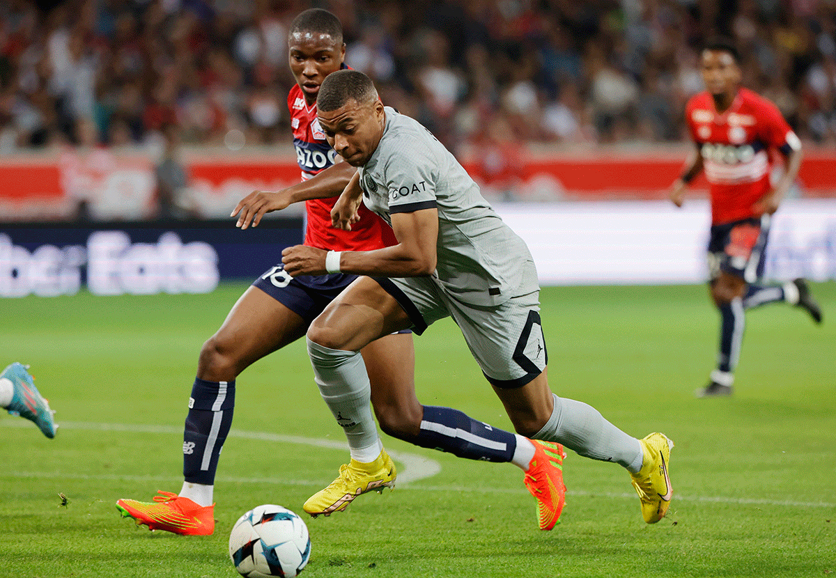 Paris St Germain's Kylian Mbappe in action with Lille's Bafode Diakite