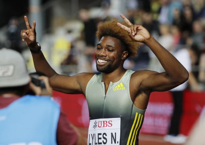Noah Lyles of the United States raies his hands in triumph after winning the men's 200 metres, his third Diamond League title of the season.