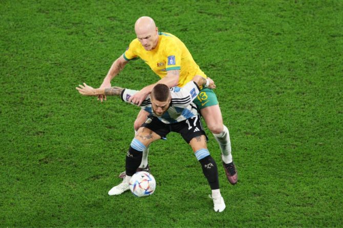  Argentina's Alejandro Gomez is challenged by Australia's Aaron Mooy