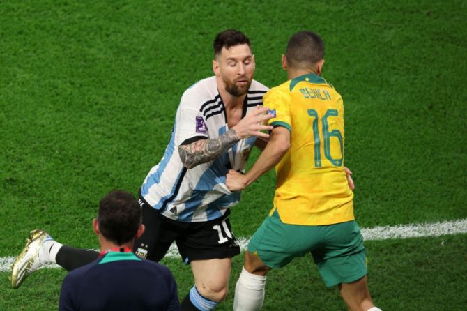 Lionel Messi of Argentina tussles with Aziz Behich of Australia