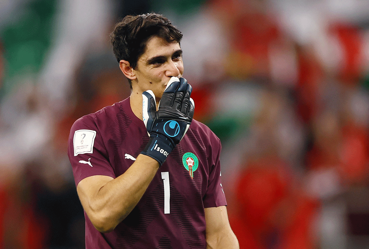 Morocco's Yassine Bounou celebrates winning the penalty shootout as Morocco progress to the quarter finals 