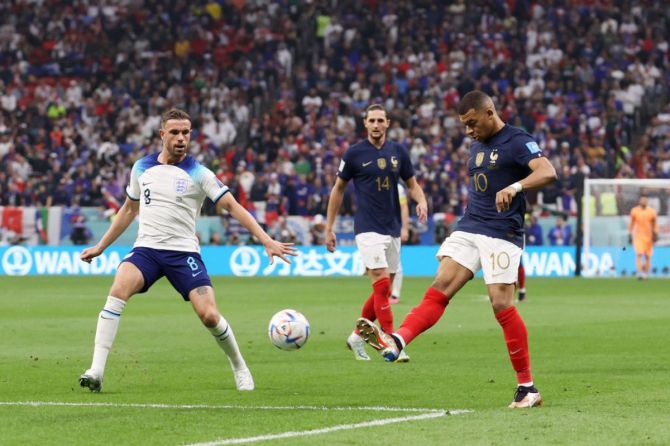 France's Kylian Mbappe battles for possession with England's Jordan Henderson