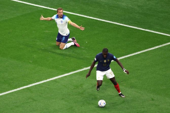 Harry Kane of England reacts after a challenge from Dayot Upamecano of France