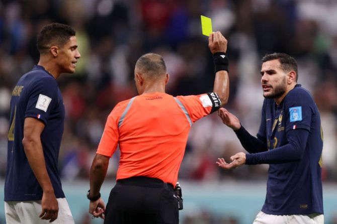 France's Theo Hernandez is shown a yellow card by Referee Wilton Sampaio