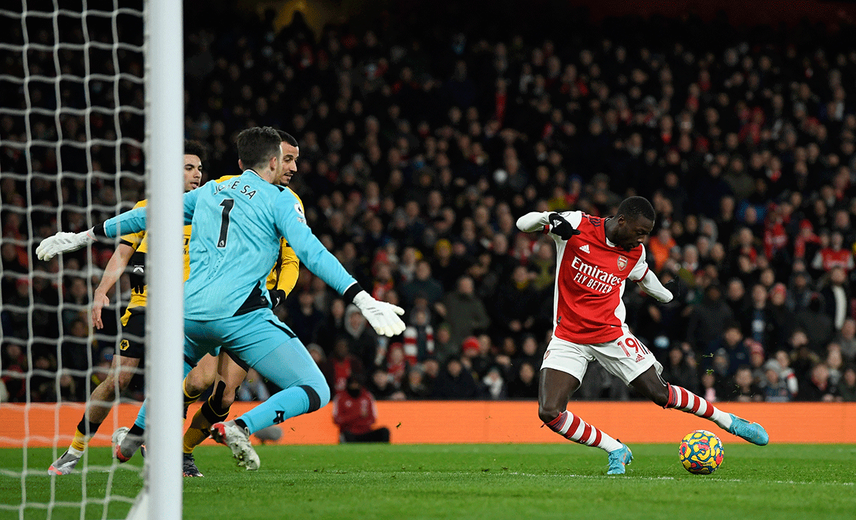 Arsenal's Nicolas Pepe scores their first goal against Wolverhampton Wanderers during their EPL match at Emirates Stadium, London on Thursday