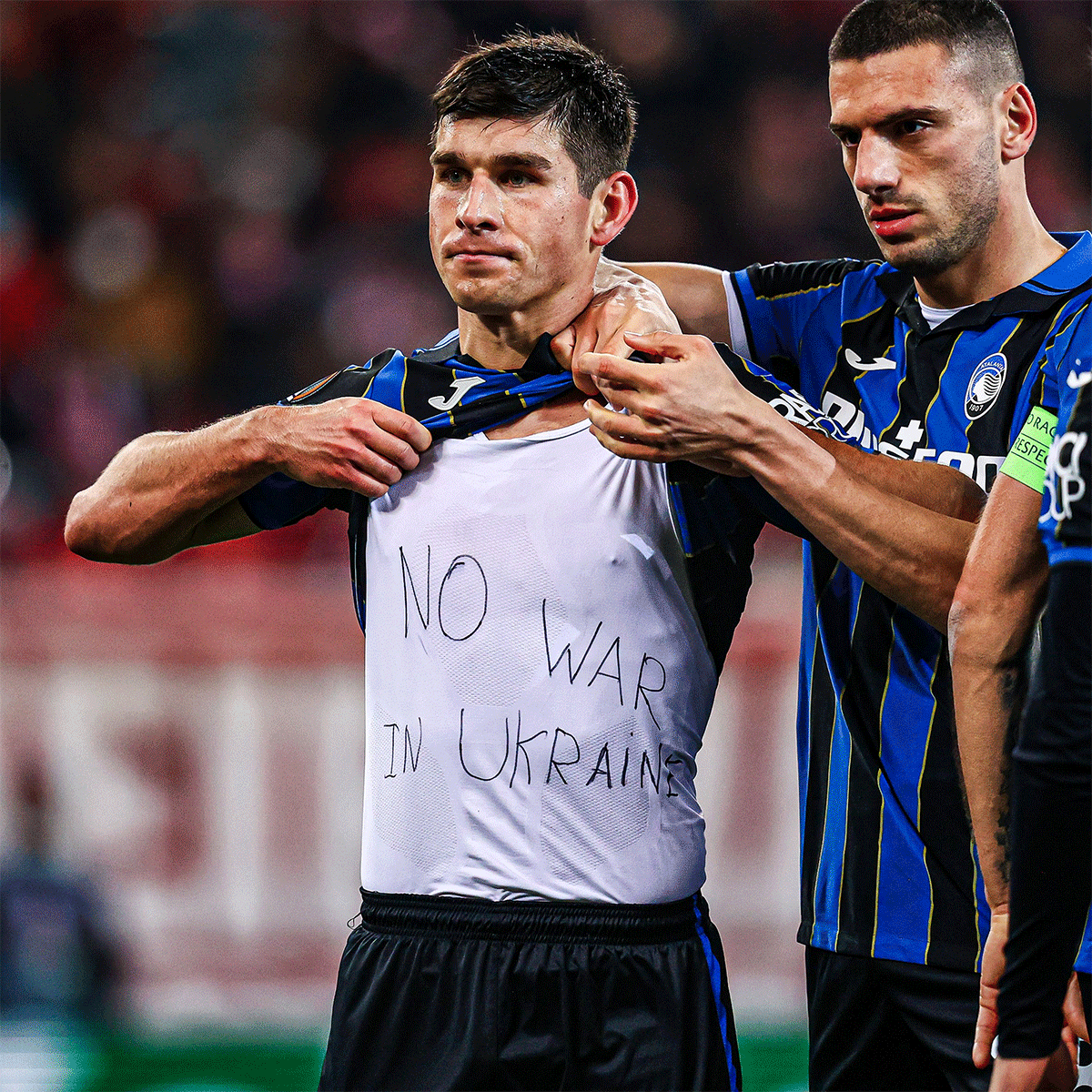 Atalanta's Ukranian winger Ruslan Malinovskyi who scored two goals against Olympiacos in their Europa Champions League match on Thursday, shows his shirt that says 'No war in Ukraine'.