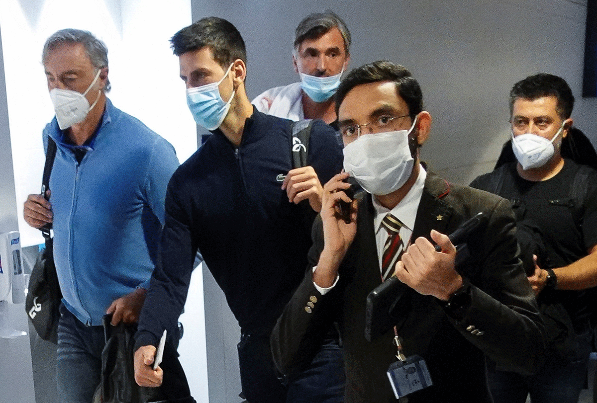 Serbian tennis player Novak Djokovic walks with his team after landing at Dubai Airport after the Australian Federal Court upheld a government decision to cancel his visa to play in the Australian Open, in Dubai, United Arab Emirates, on Monday