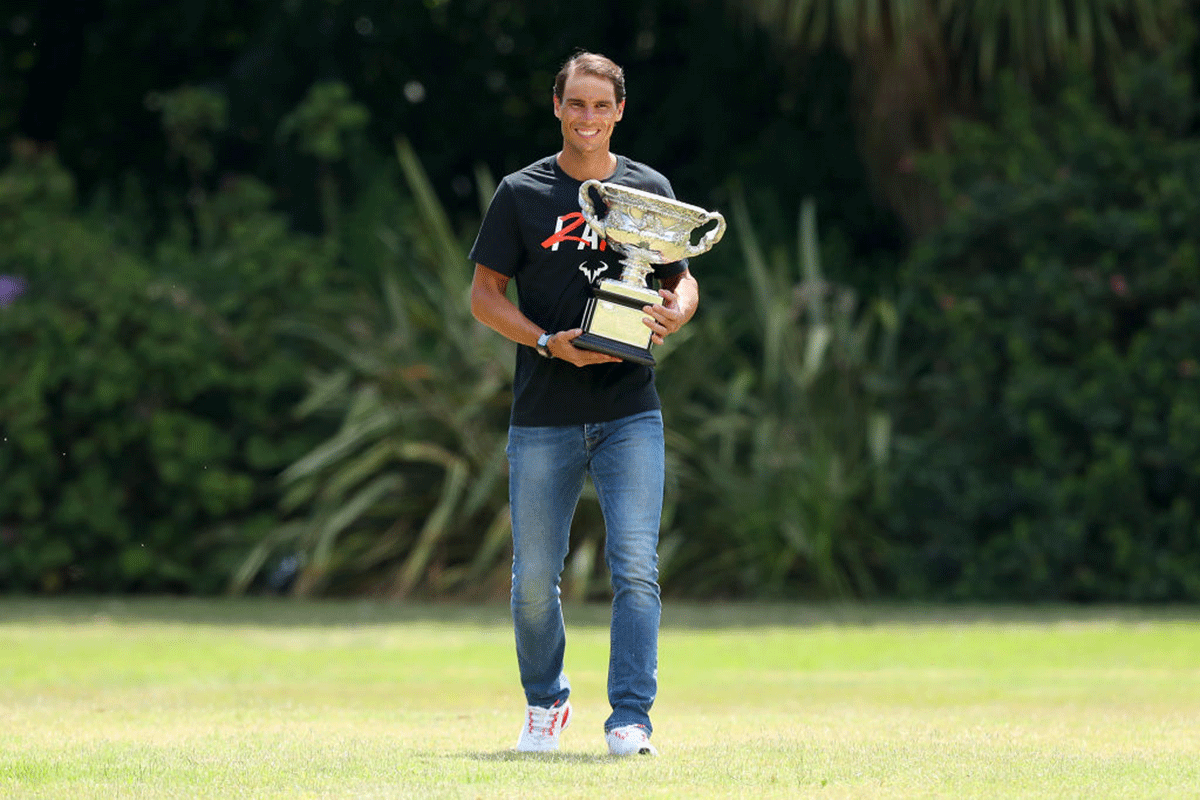 Rafael Nadal walks with the Norman Brookes Challenge Cup after winning the 2022 Australian Open Men's singles final, for a photo shoot at Government House in Melbourne, Australia, on Monday