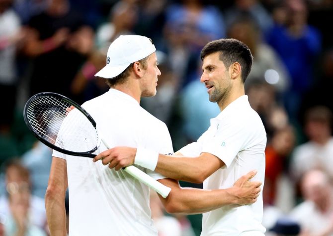 Novak Djokovic shakes hands with Tim van Rijthoven after winning their fourth round match.