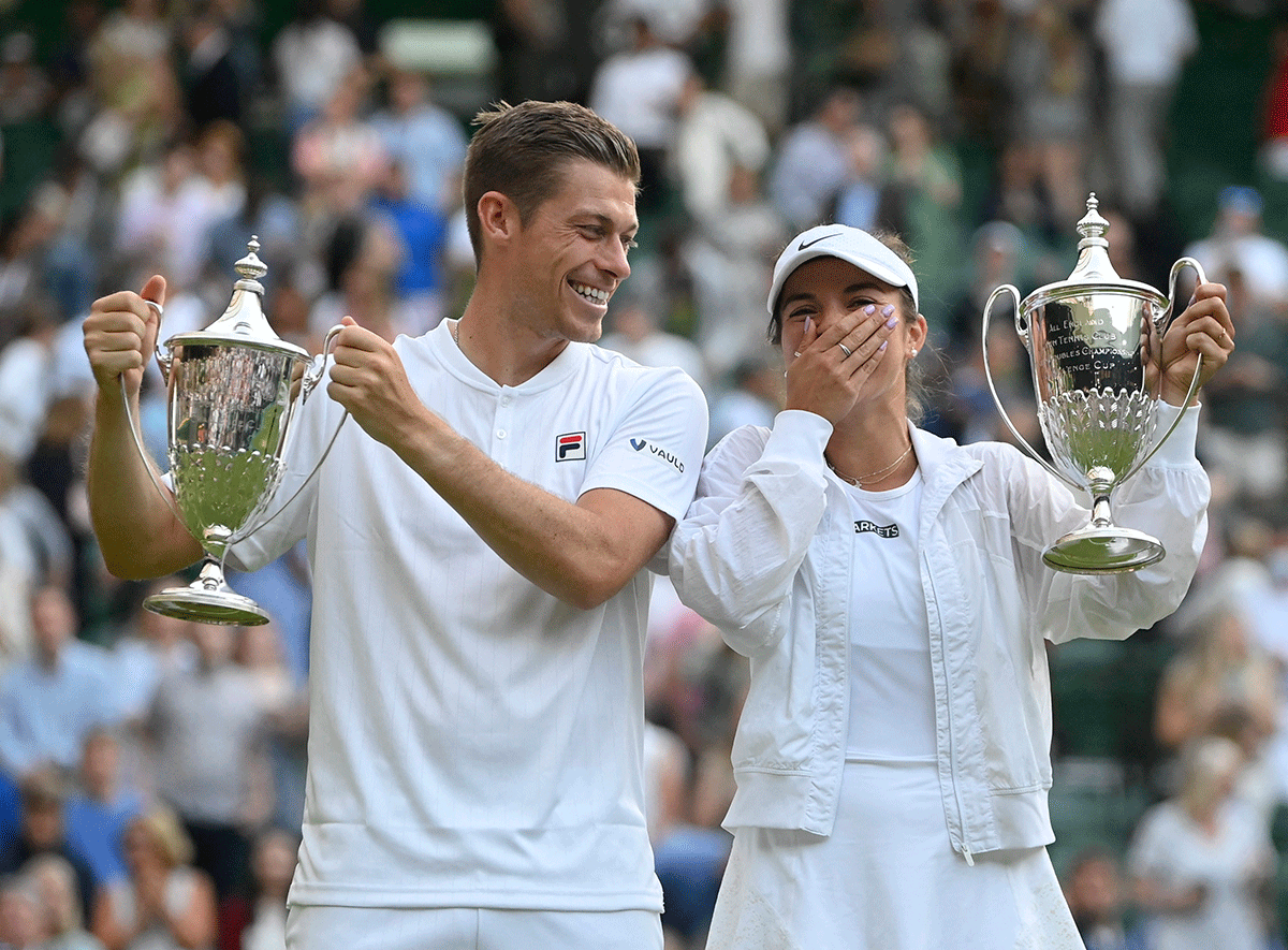 Desirae Krawczyk of the US and Britian's Neal Skupski pose for a photograph with their trophies as they celebrate winning the Wimbledon mixed doubles final against Australia's Matthew Ebden and Samantha Stosur on Thursday