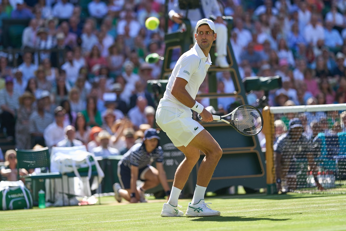 Novak Djokovic watches the ball fly past him during the Wimbledon men's singles semi-final against Great Britain's Cameron Norrie on Centre court at the All England Lawn Tennis and Croquet Club. 