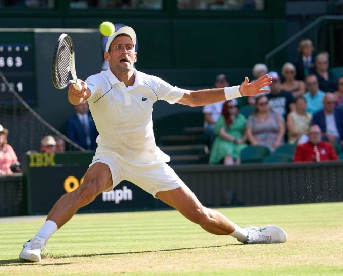 Novak Djokovic stretches to return a shot in his semi-final against Cameron Norrie.