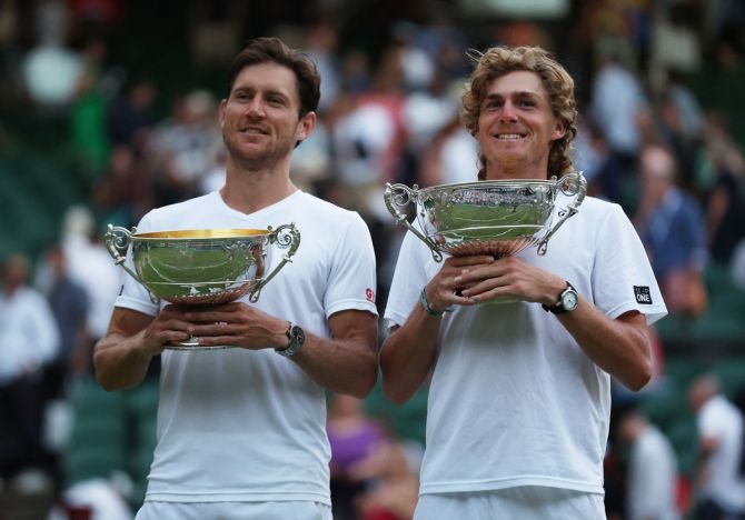 Australia's Matthew Ebden and Max Purcell celebrate with the trophy after winning the Wimbledon men's doubles final against Croatia's Nikola Mektic and Mate Pavic  at the All England Lawn Tennis and Croquet Club, London, on Saturday.