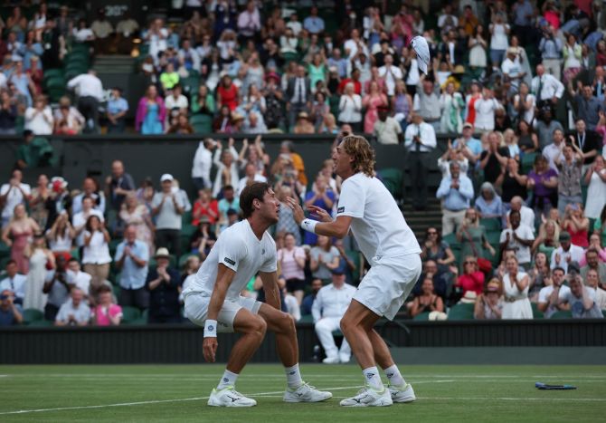 Matthew Ebden and Max Purcell celebrate clinching victory after an epic four hours and 11 minutes battle.