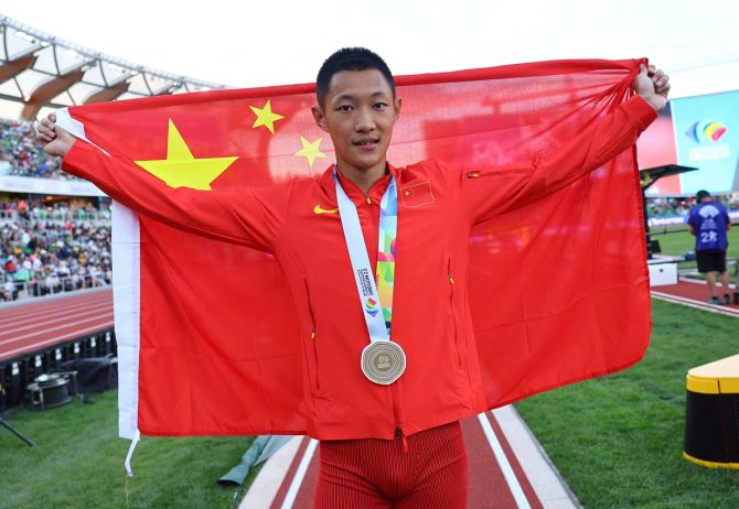Gold medallist China's Wang Jianan celebrates after winning the men's long jump final.