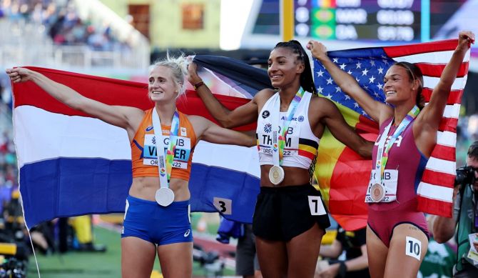 Belgium's Nafissatou Thiam celebrates alongside silver medallist Anouk Vetter of the Netherlands and bronze medallist Anna Hall of the United States after winning the women's heptathlon.