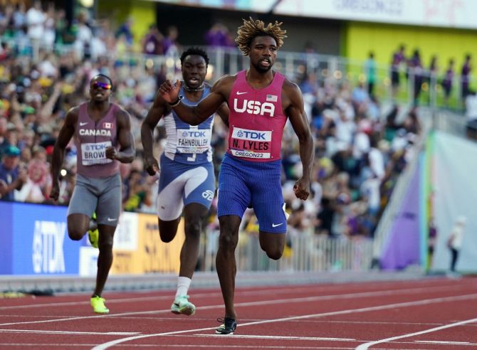 Noah Lyles crosses the line first to win the men's 200 metres final.