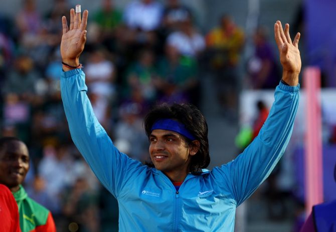 Neeraj Chopra is all smiles as he climbs on the podium for the medal ceremony.