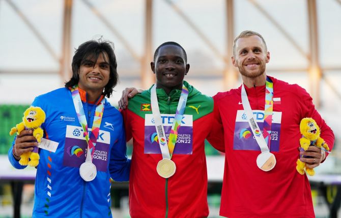 Gold medallist Anderson Peters of Grenada celebrates on the podium alongside silver medallist Neeraj Chopra and bronze medallist Jakub Vadlejch of Czech Republic during the medal ceremony for the men's javelin throw.