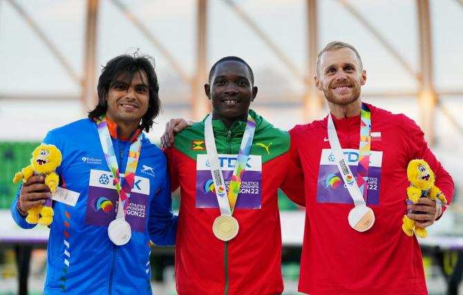 Gold medallist Anderson Peters of Grenada celebrates on the podium alongside silver medallist Neeraj Chopra and bronze medallist Jakub Vadlejch of Czech Republic during the medal ceremony for the men's javelin throw.