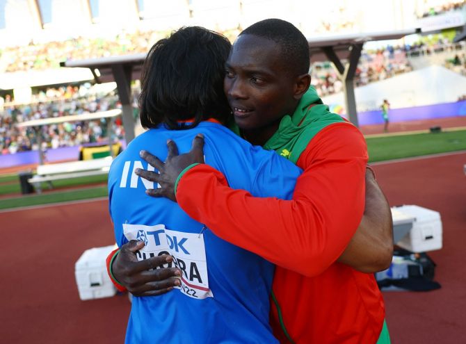 Anderson Peters and Neeraj Chopra embrace at the end of the javelin throw final.