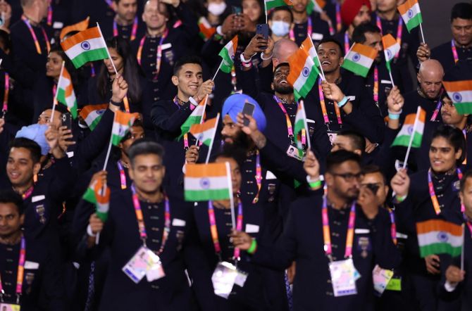 Members of the Indian contigent wave the tricolour during the athletes parade.