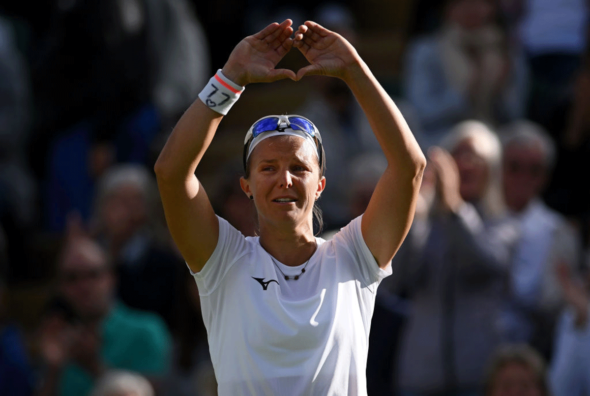 Belgium's Kirsten Flipkens shows appreciation to spectators in her final match after announcing her retirement from singles, following her second round match against Romania's Simona Halep.