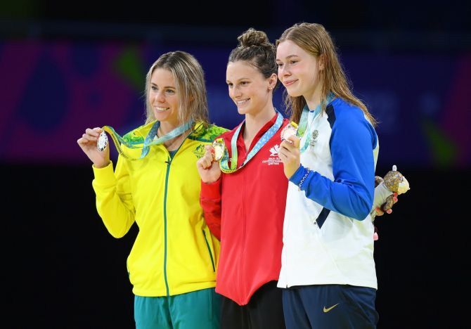 (L-R) Silver medallist Kiah Melverton of Australia, gold medallist Summer McIntosh of Canada and bronze medallist Katie Shanahan of Scotland pose with their medals from the women’s 400m individual medley.