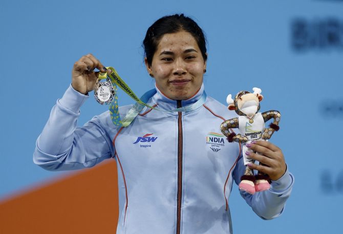 India's Bindyarani Devi Sorokhaibam celebrates on the podium with her silver medal from the women's 55kg weightlifting competition at the Commonwealth Games on Saturday.