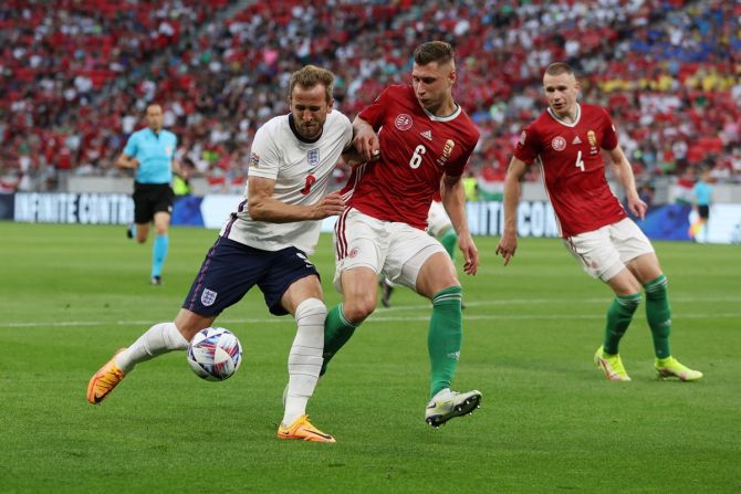 England's Harry Kane battles for possession with Hungary's Willi Orban.