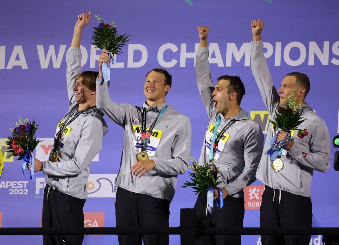 Men's 4x100m freestyle relay gold medallists, Caeleb Dressel, Ryan Held, Justin Ress and Brooks Curry of the United States celebrate on the podium.