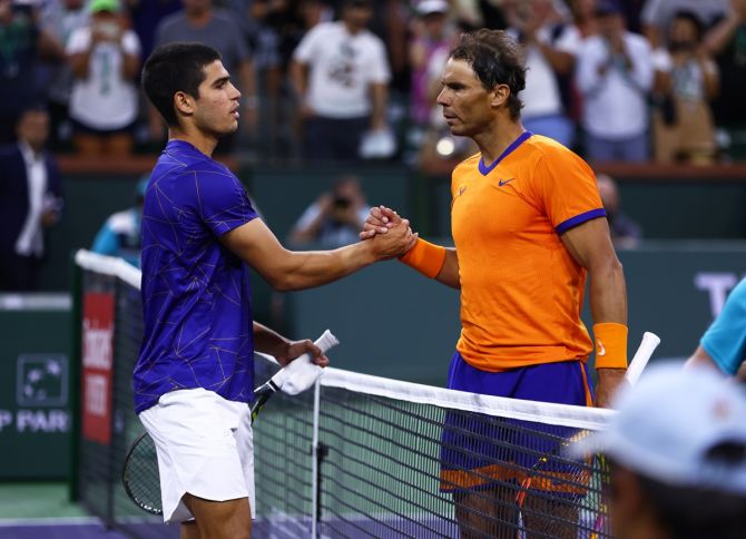 Rafael Nadal and Carlos Alcaraz embrace at the net after their three-set semi-final.