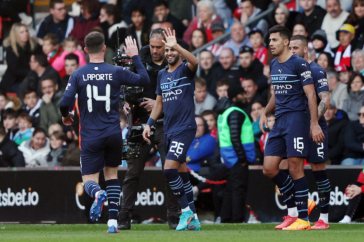 Manchester City's Riyad Mahrez celebrates with teammates on netting their fourth goal against Southampton during their FA Cup quarter-final at St Mary's Stadium in Southampton on Sunday 