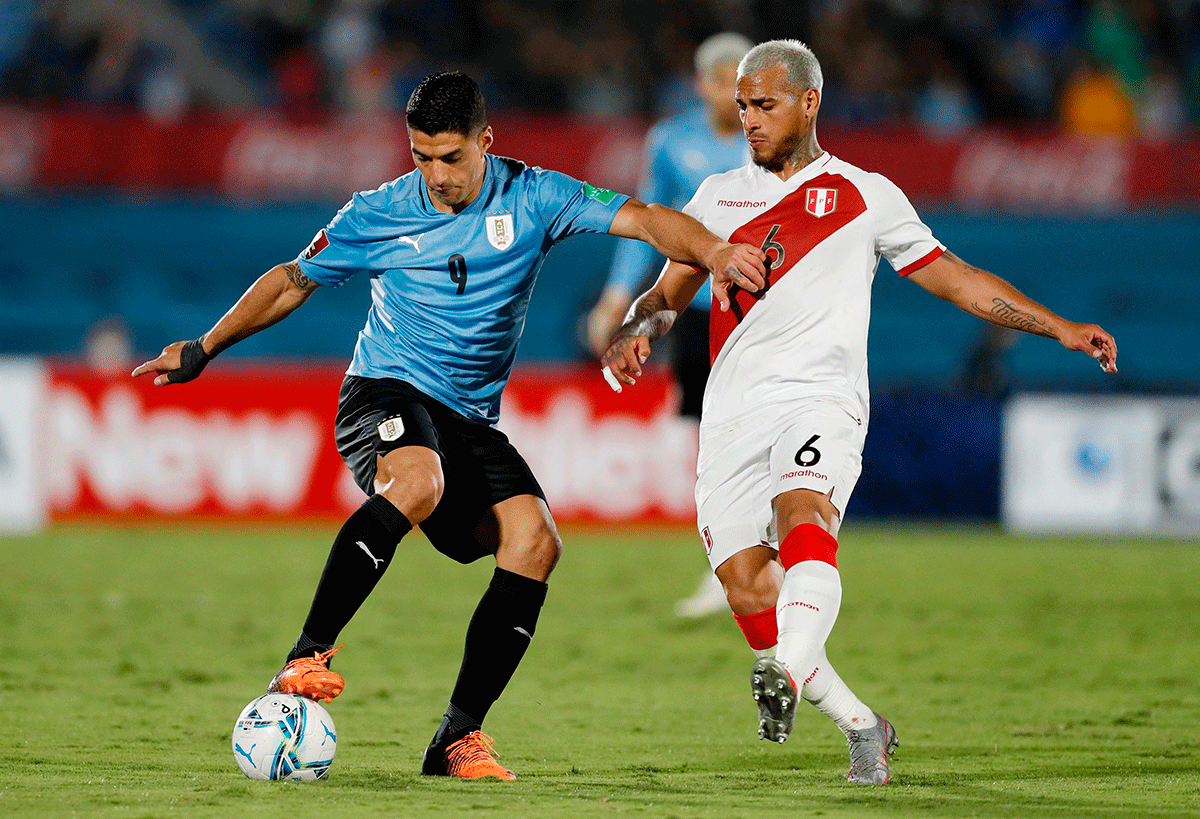 Uruguay's Luis Suarez in action with Peru's Miguel Trauco during the World Cup - South American Qualifiers at Estadio Centenario, Montevideo, Uruguay on Thursday