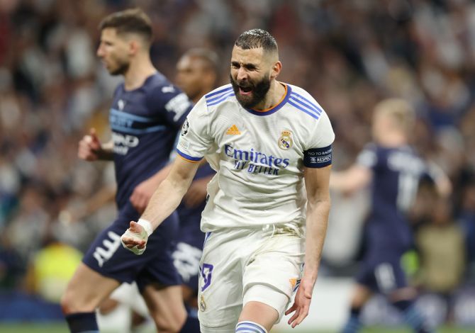 Karim Benzema celebrates after scoring Real Madrid's third goal from the penalty spot.