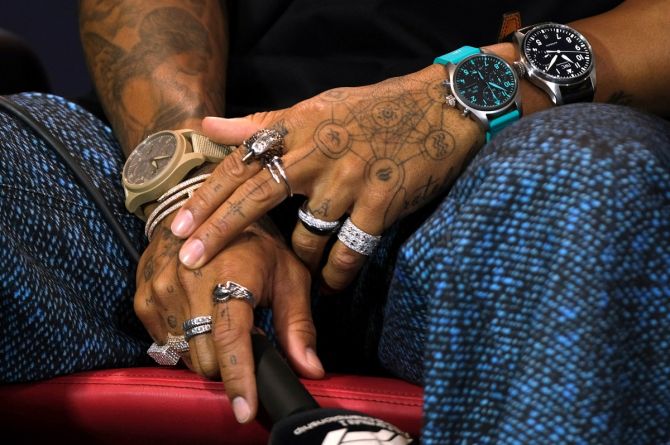 The seven-time Formula One World champion attended the pre-race press conference wearing rings on every finger, three large watches (set to different time zones) and a bangle.