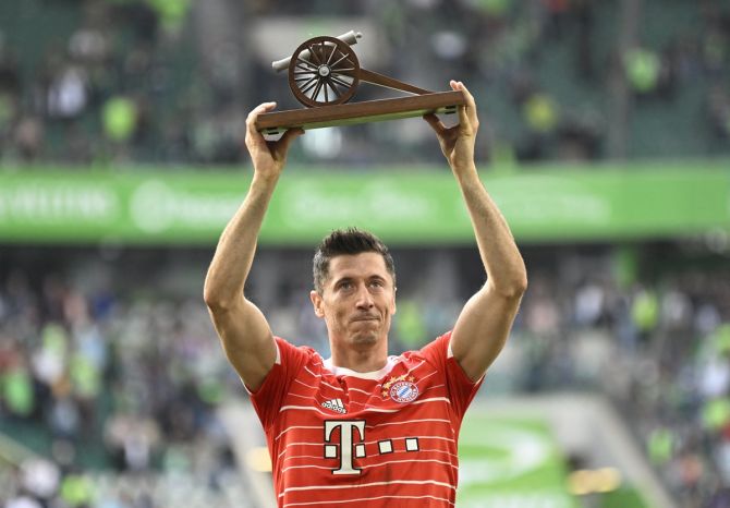 Bayern Munich's Robert Lewandowski celebrates with the top goalscorer trophy after the Bundesliga match against VfL Wolfsburg at Volkswagen Arena, Wolfsburg, on Saturday.