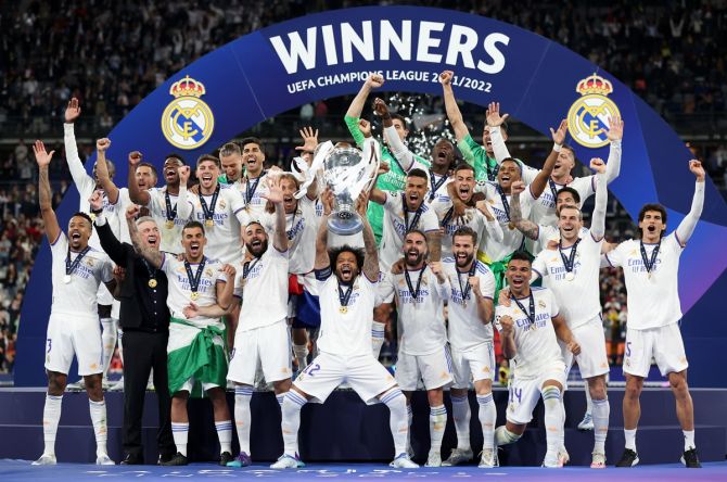 Real Madrid players celebrate with the UEFA Champions League Trophy after beating Liverpool in the final at the Stade de France in Paris, on Saturday.